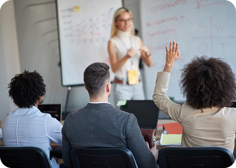 Woman speaking to audience in a classroom.